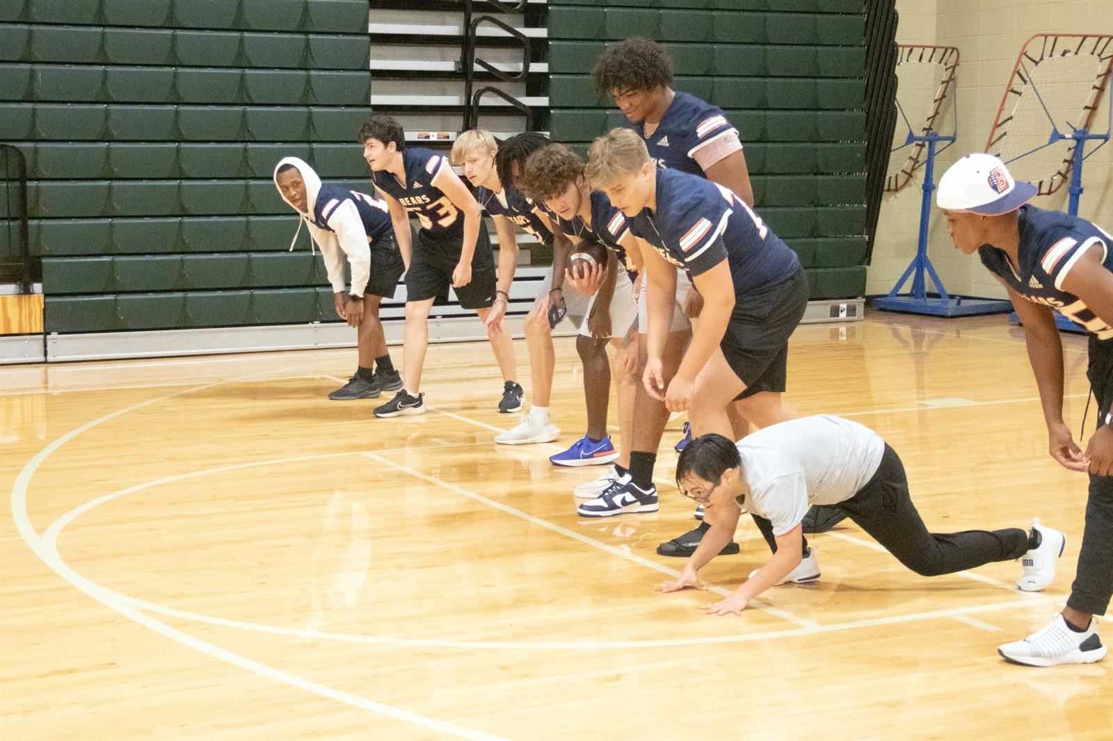 Bridgeland High School football players set up during a running station at Camp Courage on May 16 at Cypress Falls.